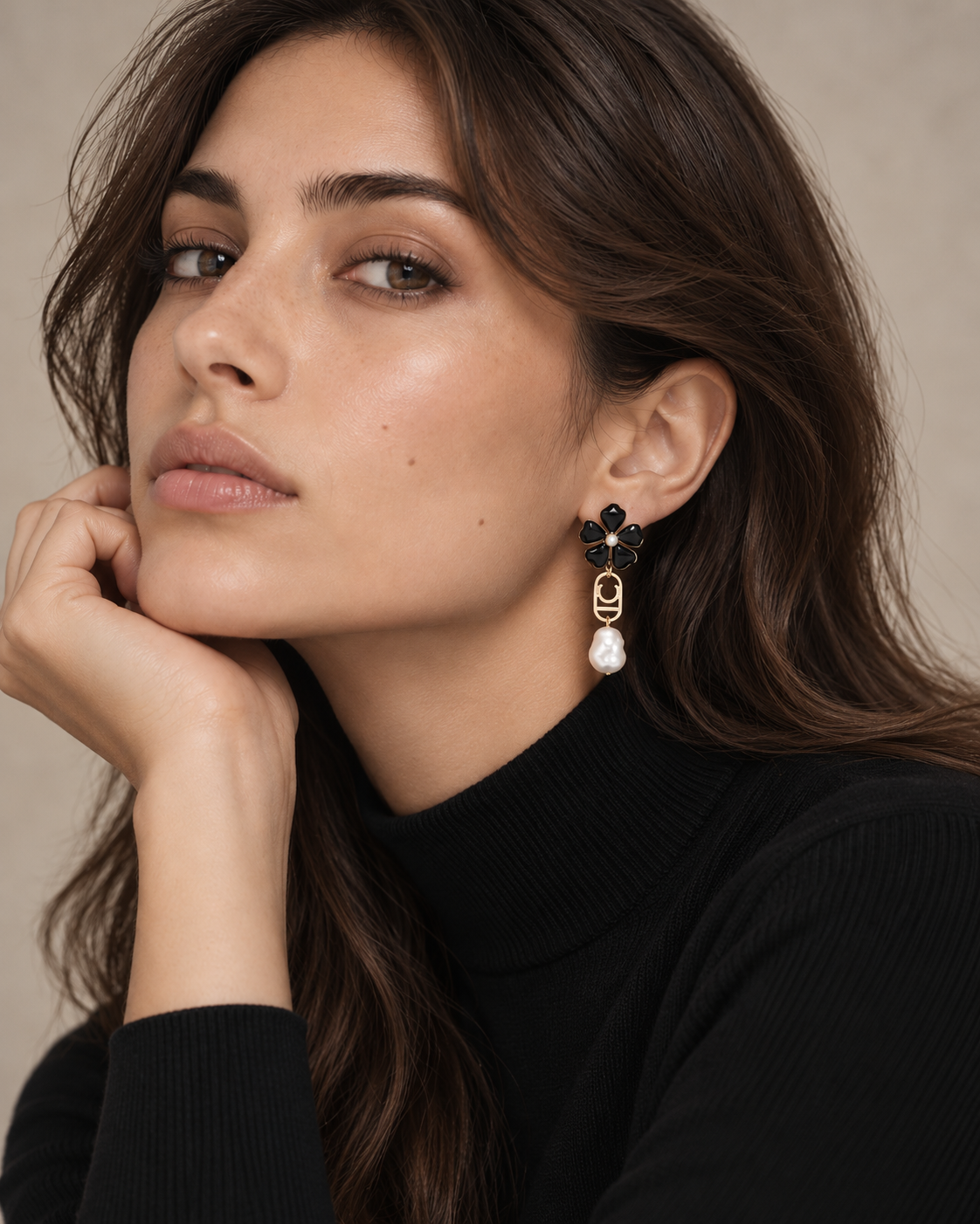 Pendientes Lola Casademunt largos flor y perla - look mujer Modelo con pendientes largos Lola Casademunt de flor negra, logo ovalado dorado y perla blanca, combinados con jersey negro de cuello alto